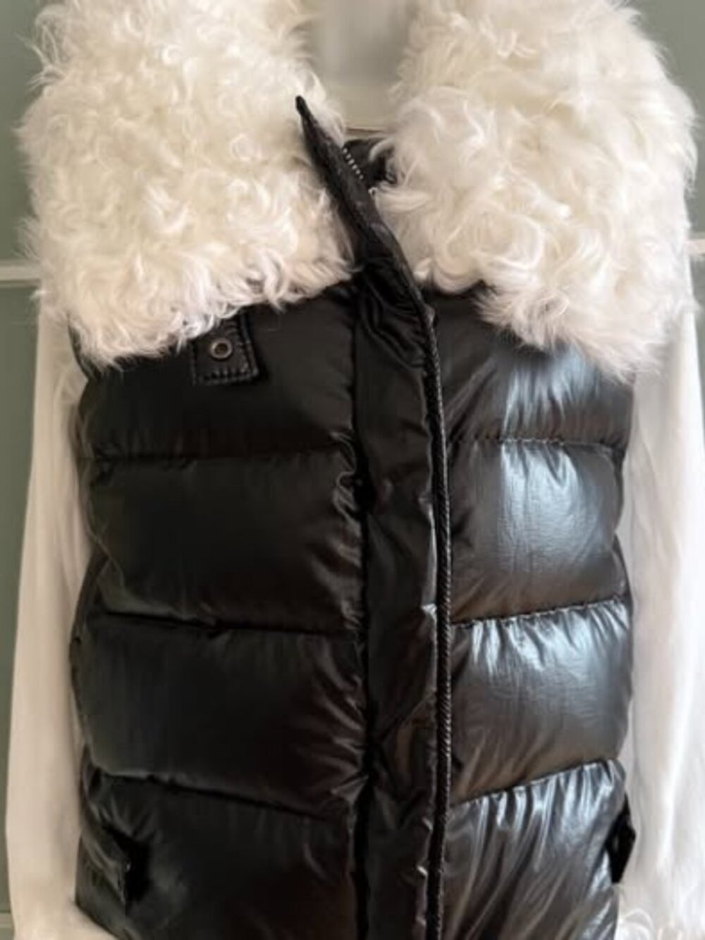 Beautiful black winter puffer vest featuring a dramatic white curly shearling